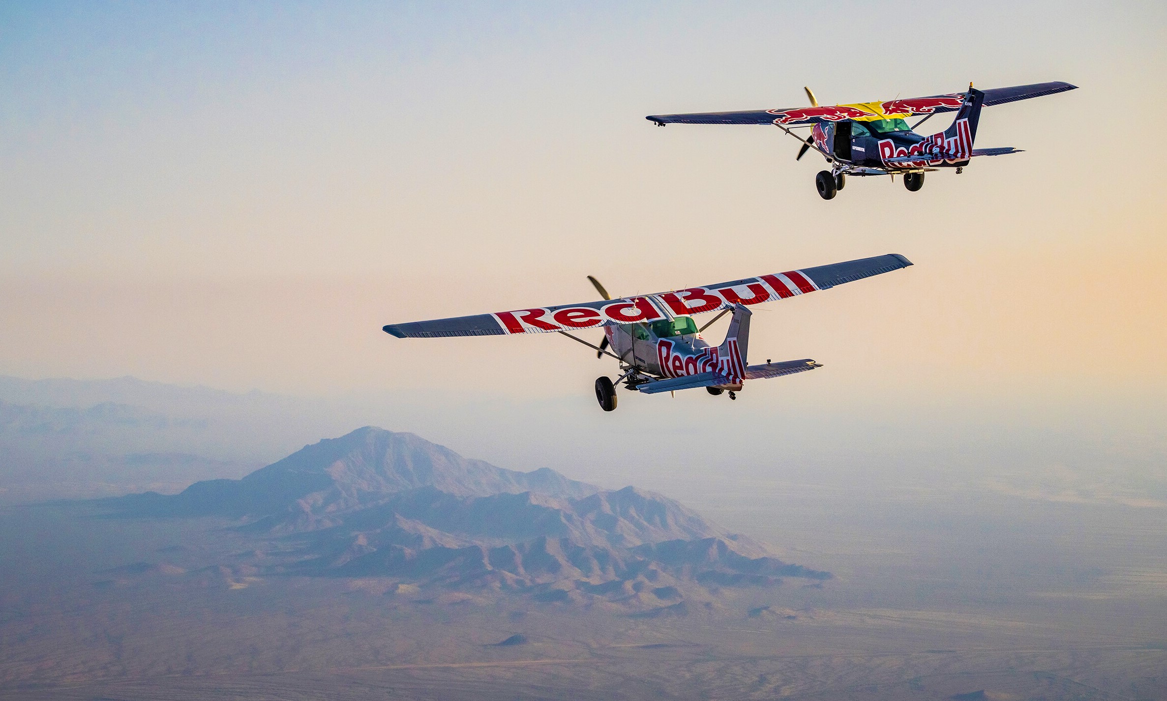 Instead of making history , Redbull daredevil pilots had their flying licenses revoked by the Federal Aviation Administration , after the aircraft crash !